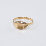14K yellow gold Daphne laurel leaf ring with brushed matte finish and ten natural diamonds along the leaf design