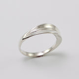 Inspired by the Greek myth of the goddess Daphne and her transformation into the laurel tree, this ring is crafted in sterling silver as a symbolic representation of the laurel leaf—an enduring emblem of triumph and achievement.
The sculptural leaf gently folds around the finger, forming an elegant and fluid band that echoes the organic beauty of nature.
Designed to be worn alone or stacked, this piece is a graceful expression of handcrafted artistry and mythological inspiration, blending timeless symboli