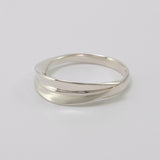 Inspired by the Greek myth of the goddess Daphne and her transformation into the laurel tree, this ring is crafted in sterling silver as a symbolic representation of the laurel leaf—an enduring emblem of triumph and achievement.
The sculptural leaf gently folds around the finger, forming an elegant and fluid band that echoes the organic beauty of nature.
Designed to be worn alone or stacked, this piece is a graceful expression of handcrafted artistry and mythological inspiration, blending timeless symboli