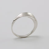 Inspired by the Greek myth of the goddess Daphne and her transformation into the laurel tree, this ring is crafted in sterling silver as a symbolic representation of the laurel leaf—an enduring emblem of triumph and achievement.
The sculptural leaf gently folds around the finger, forming an elegant and fluid band that echoes the organic beauty of nature.
Designed to be worn alone or stacked, this piece is a graceful expression of handcrafted artistry and mythological inspiration, blending timeless symboli