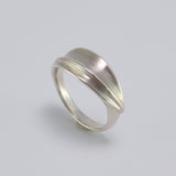 Inspired by the Greek myth of the goddess Daphne and her transformation into the laurel tree, this ring is crafted in sterling silver as a symbolic representation of the laurel leaf-an enduring emblem of triumph and achievement.
The sculptural leaf gently folds around the finger, forming an elegant, fluid band that echoes nature's organic beauty.
Designed to be worn alone or stacked, this piece is a graceful expression of handcrafted artistry and mythological inspiration, blending timeless symbolism with