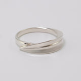 Inspired by the Greek myth of the goddess Daphne and her transformation into the laurel tree, this ring is crafted in sterling silver as a symbolic representation of the laurel leaf—an enduring emblem of triumph and achievement.

The sculptural leaf gently folds around the finger, forming an elegant and fluid band that echoes the organic beauty of nature.

Designed to be worn alone or stacked, this piece is a graceful expression of handcrafted artistry and mythological inspiration, blending timeless symboli