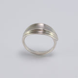 Inspired by the Greek myth of the goddess Daphne and her transformation into the laurel tree, this ring is crafted in sterling silver as a symbolic representation of the laurel leaf-an enduring emblem of triumph and achievement.

The sculptural leaf gently folds around the finger, forming an elegant, fluid band that echoes nature's organic beauty.

Designed to be worn alone or stacked, this piece is a graceful expression of handcrafted artistry and mythological inspiration, blending timeless symbolism with 